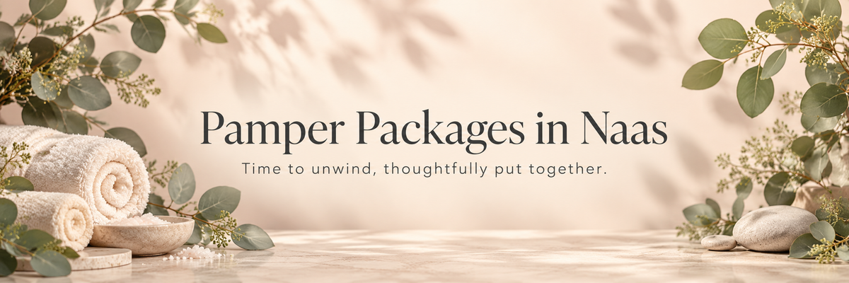 Promotional banner for 'Pamper Packages in Naas' featuring rolled towels, green leaves, and stones on a warm beige background with soft shadows.