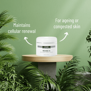 DMK Revise A Cream jar on a wooden stand with botanical greenery and product information