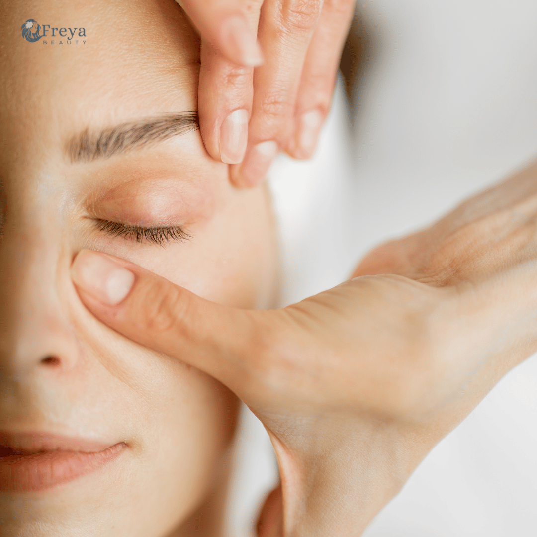 Close-up of a person receiving a facial massage with Freya Skincare logo.