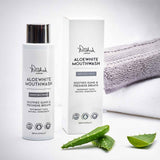 A bottle of Polished London Aloewhite Mouthwash with its packaging box, displayed alongside a green aloe vera plant and a white cotton gum, emphasizing the product's natural ingredients.