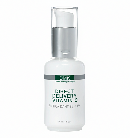 A white, pump-mounted bottle labeled 'DMK Direct Delivery Vitamin C Antioxidant Serum' against a plain background.