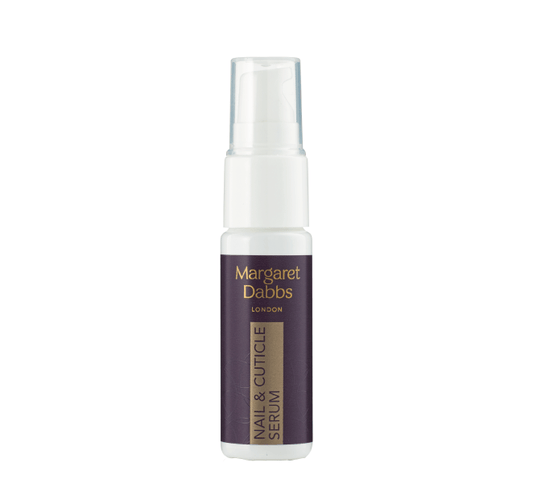 Margaret Dabbs Nourishing Nail & Cuticle Serum in a white spray bottle with a purple label.