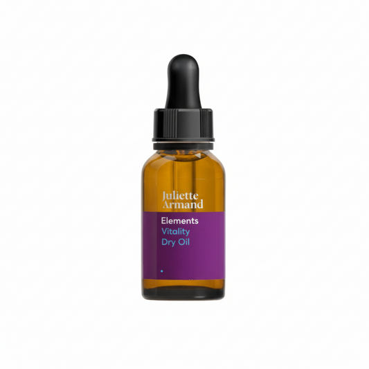 A bottle of Juliette Armand Vitality Dry Oil with a dropper cap.